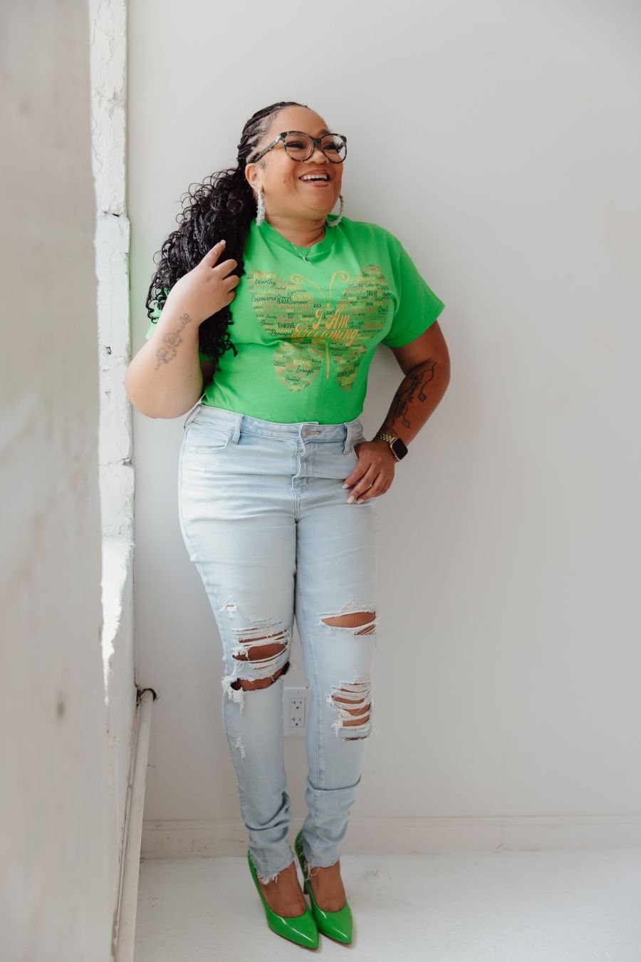 Coach Tara Tucker wearing the I Am Becoming T-shirt in Kelly green